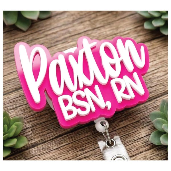 Personalized pink and white RN badge reel with a name and nursing credentials